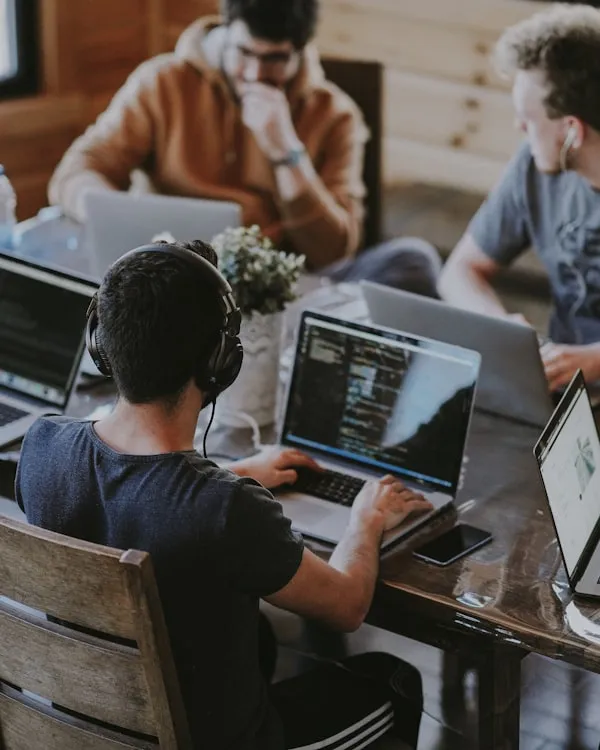 A diverse team of professionals collaborating with laptops in an open office, representing startups.