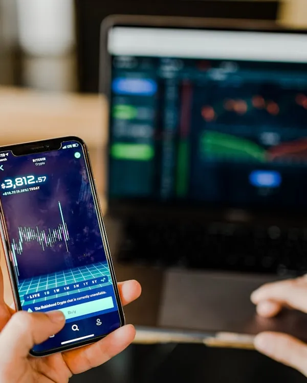 Close-up of a mobile screen showing stock market analytics, representing climate investors.